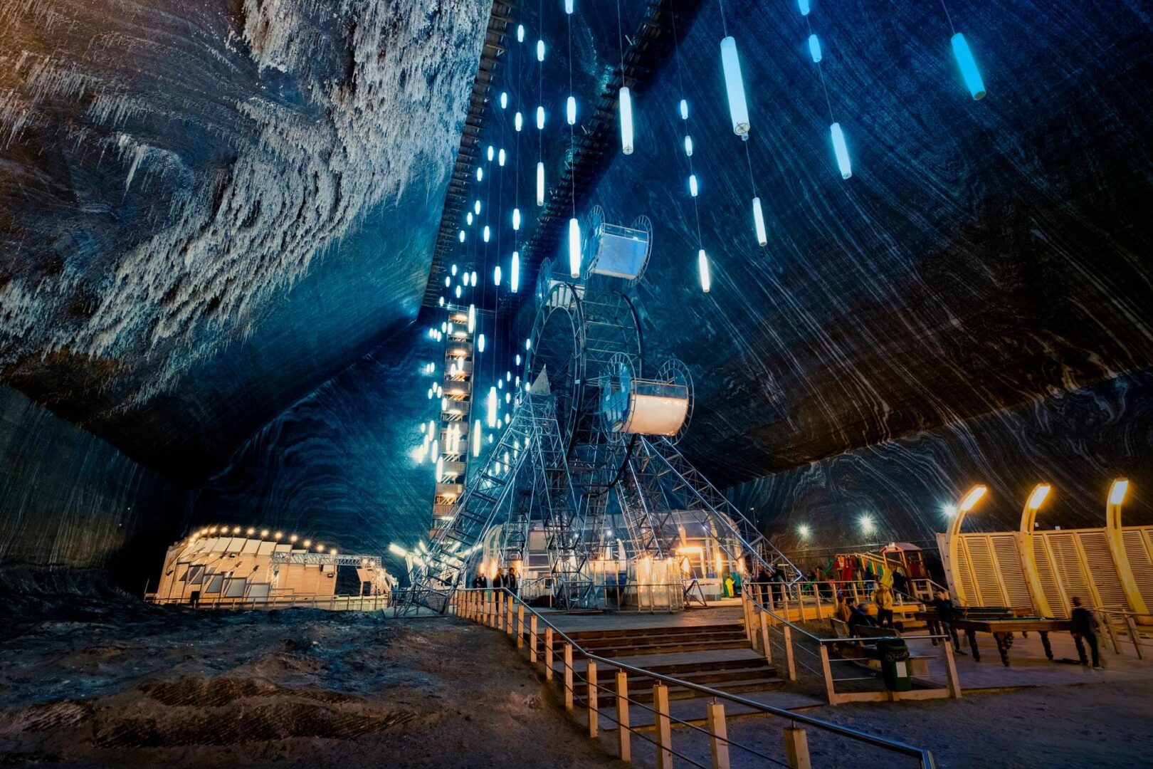 Illuminated underground cavern featuring a Ferris wheel