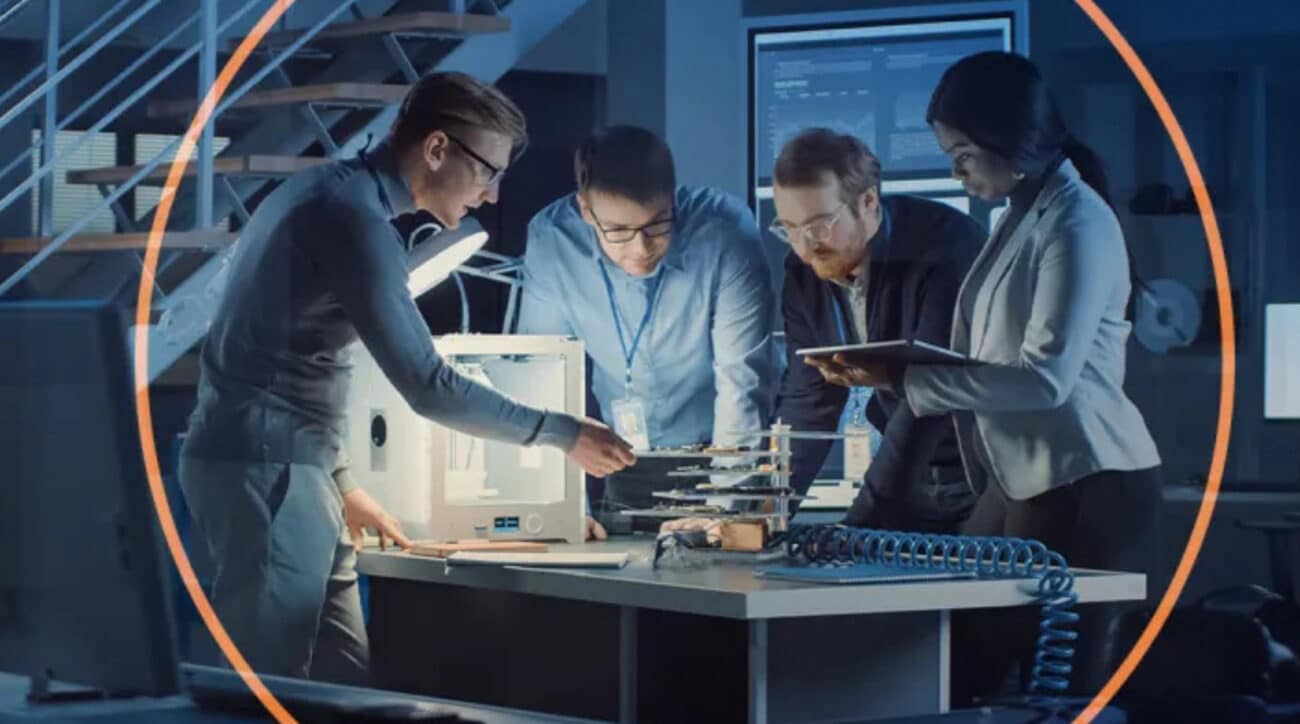 Engineers examining 3D-printed prototype on table