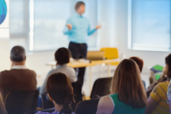 Classroom presentation with attentive audience listening.