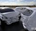 White cars in a staged crash test.