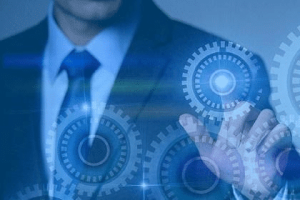 A man in a suit and tie holding out his hand.