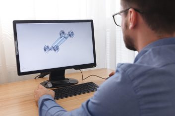 A man sitting at his computer looking at the screen